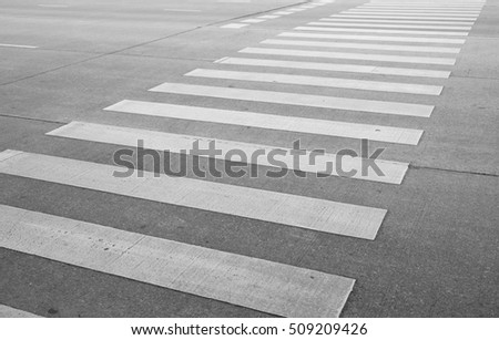 Zebra cross walk on asphalt road.
