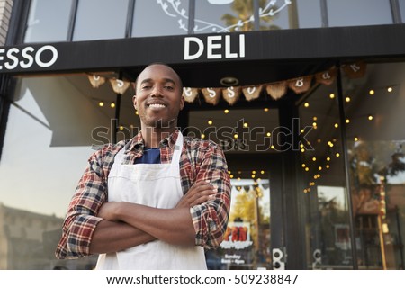 Black male business owner standing outside coffee shop Royalty-Free Stock Photo #509238847