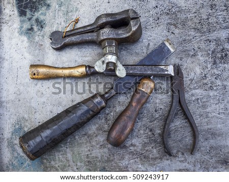 Old rusty small tools on metal background. Selective focus