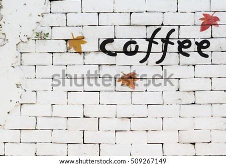 Cofee word painted over white brick wall.