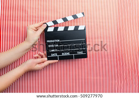 movie marker or clapper board set against a colorfull background, cinema concept
