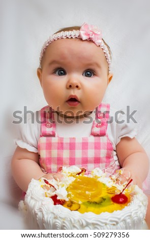 Little girl with a sweet cake in his hands