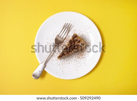 Aerial view of a slice of toffee cheesecake dessert on a yellow background