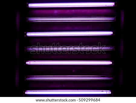 road of violet horizontal long lamp against dark background, horizontal lamps divided into sections with lights against dark background, high quality resolution, ceiling office lamp with light