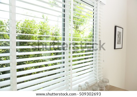  venetian blinds by the window Royalty-Free Stock Photo #509302693