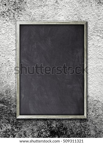 Single blank blackboard frame on gray weathered concrete wall background