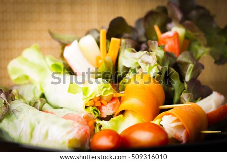 Close up of fresh salad of lettuce, cucumber and tomato on plate for healthy eating.
Fresh vegetable salad in Black plate  on wood table. Salad for healthy. Fresh raw vegetables salad background.