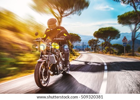 motorbike on the road riding. having fun driving the empty road on a motorcycle tour journey. copyspace for your individual text. Royalty-Free Stock Photo #509320381