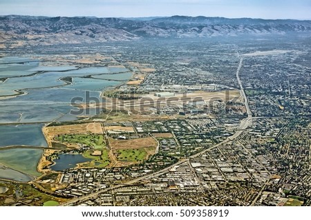 Aerial view of San Francisco bay area in California United States of America scenery with Moffett airfield city of San Jose 101 root bayshore freeway satellite landmark