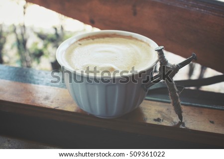 Cross and coffee cup