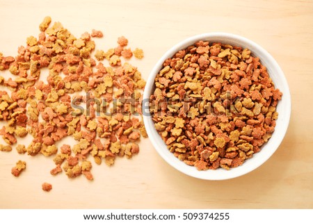 Dry cat foods over wooden table background