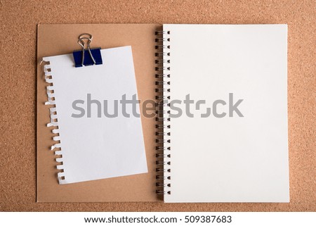 blank torn paper and blank note book on wooden table