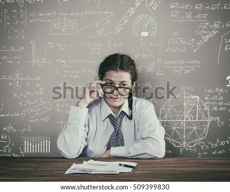 Young woman stay at the desk and explain the problem on the blackboard - teacher