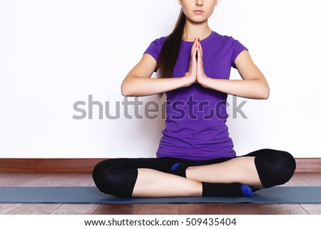 Beautiful sporty fit yogini woman practices yoga asana , white wall, space for text