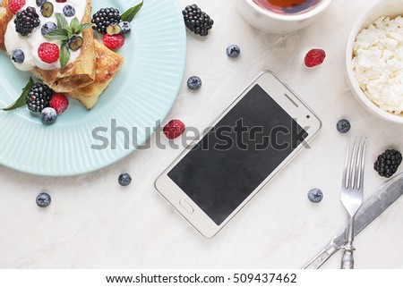 Morning mock up with breakfast. pancakes, phone and berries on white background