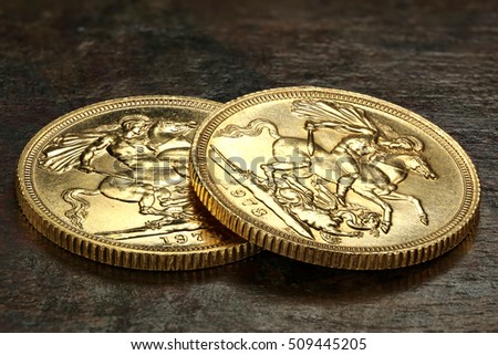 British Sovereign gold coins on rustic wooden background Royalty-Free Stock Photo #509445205