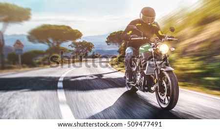 motorbike on the road riding. having fun driving the empty road on a motorcycle tour journey. copyspace for your individual text. Royalty-Free Stock Photo #509477491