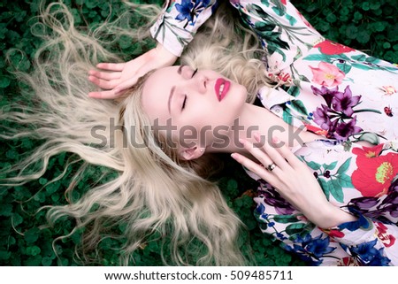 happy young blondie european woman on the grass