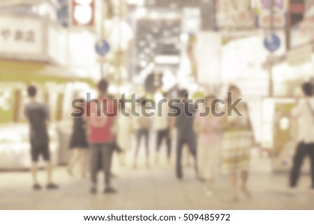 Blurred image of crowded people shopping with vintage color effected
