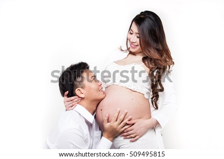 Beautiful young Asian couple expecting baby.