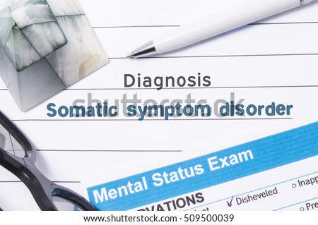 Psychiatric Diagnosis Somatic Symptom Disorder. Medical book or form with the name of diagnosis Somatic Symptom Disorder is on table of doctor surrounded by questionnaire to determine mental state