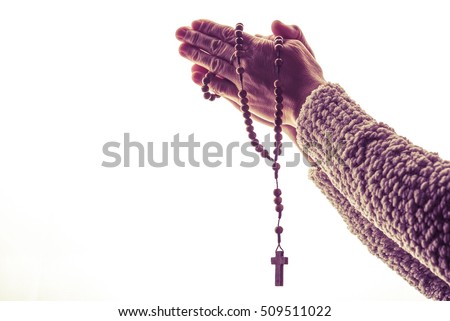 The Rosary Prayer. Woman Praying with Wooden Rosary. Closeup Isolated on White. Royalty-Free Stock Photo #509511022