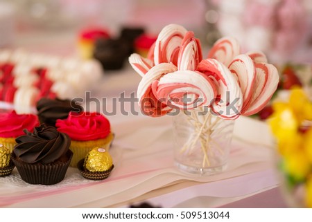 Candy Bar decorated by Delicious sweet buffet with cupcakes and other desserts/candies,happy birthday concept