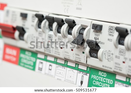 An RCD circuit breaker board displays many switches. Most are in the ON position, but one is switched down to OFF. It is the circuit for the lighting Royalty-Free Stock Photo #509531677