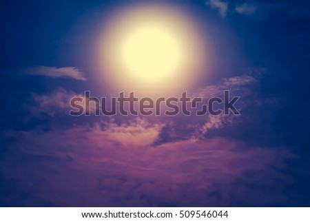 Background of nighttime sky with cloud and bright full moon with shiny. Natural beauty at night with beautiful full moon. Vintage effect tone. The moon were NOT furnished by NASA.