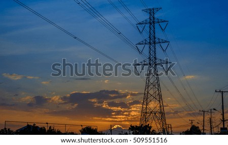 High-voltage tower on sunset background.