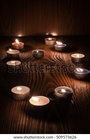 candles burning at night on a wooden background