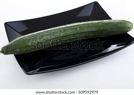 Cucumber on black plate.
