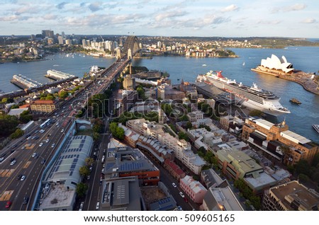 Aerial urban landscape view of Sydney Harbor at sunset in New South Wales, Australia.