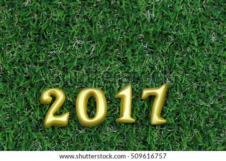 2017 real 3d objects on green grass, happy new year concept