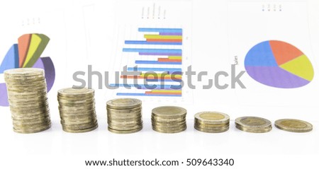 Coins stacked in increasing height on background  paper document graph
