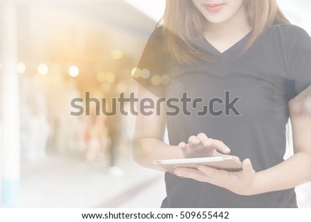 Beautiful woman chatting on mobile phone, young female in good mood reading text message on cell telephone 

