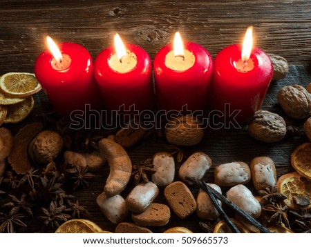 Four Red Christmas Candles with decorations and black background