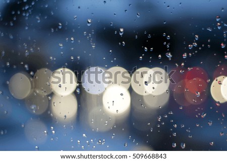Photograph of a traffic scene through a wet glass and with bokeh effect