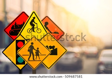 Set of traffic warning sign on blur traffic road with colorful bokeh light abstract background. Copy space of transportation and travel adventure concept. Retro tone filter color style.