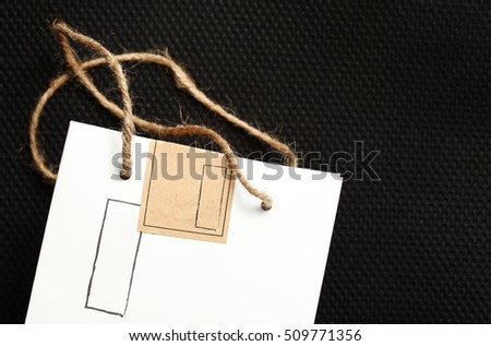 White color paper bag with natural rope handle.
