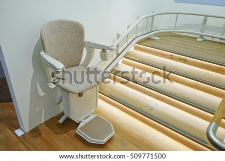 Automatic stairlift on staircase for elderly or disability in a house, Health care concept. Royalty-Free Stock Photo #509771500
