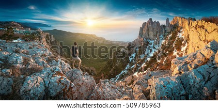 Man standing on a cliffs edge in the Crimea mountains. Ay-Petry mountain, Ukraine. Royalty-Free Stock Photo #509785963