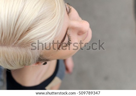 Young blonde girl walking on the city streets