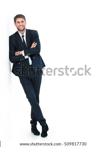 Portrait of a handsome young man in a business suit. standing near the wall Royalty-Free Stock Photo #509817730