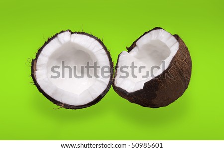opened coconut  isolated on a green background. fresh tropical fruit