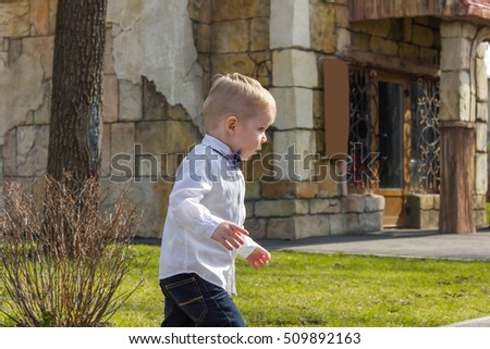 Small boy in shirt is going out the park