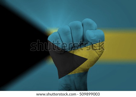 Man hand fist of BAHAMAS flag painted