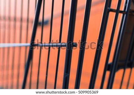 Minimalism style, Shopping cart black color and orange wall at supermarket.