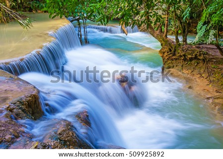 Amazing turquoise water of Kuang Si cascade waterfall. Luang Prabang, Laos. The famous attractions of Laos.