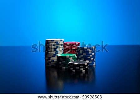 Poker chips with blue lit background